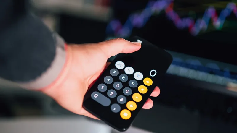Pessoa usando calculadora no celular para comparar rendimentos de investimentos