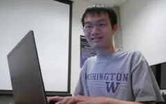 Estudante usa laptop para estudar em uma mesa, em imagem sobre o pagamento do Pé-de-Meia