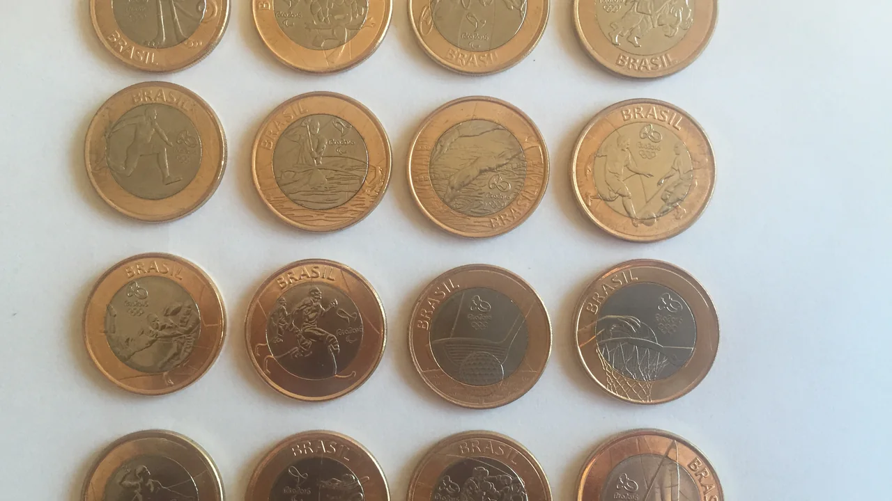 Moedas de um real sobre uma superfície, representando valores e finanças públicas
