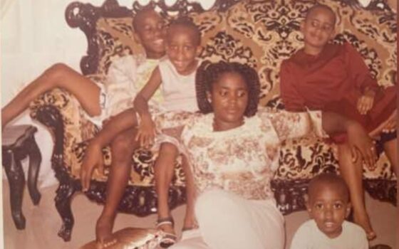 Mãe com duas crianças em casa, em uma cena de convivência familiar