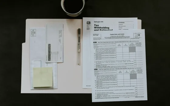 Documentos fiscais e calculadora sobre uma mesa
